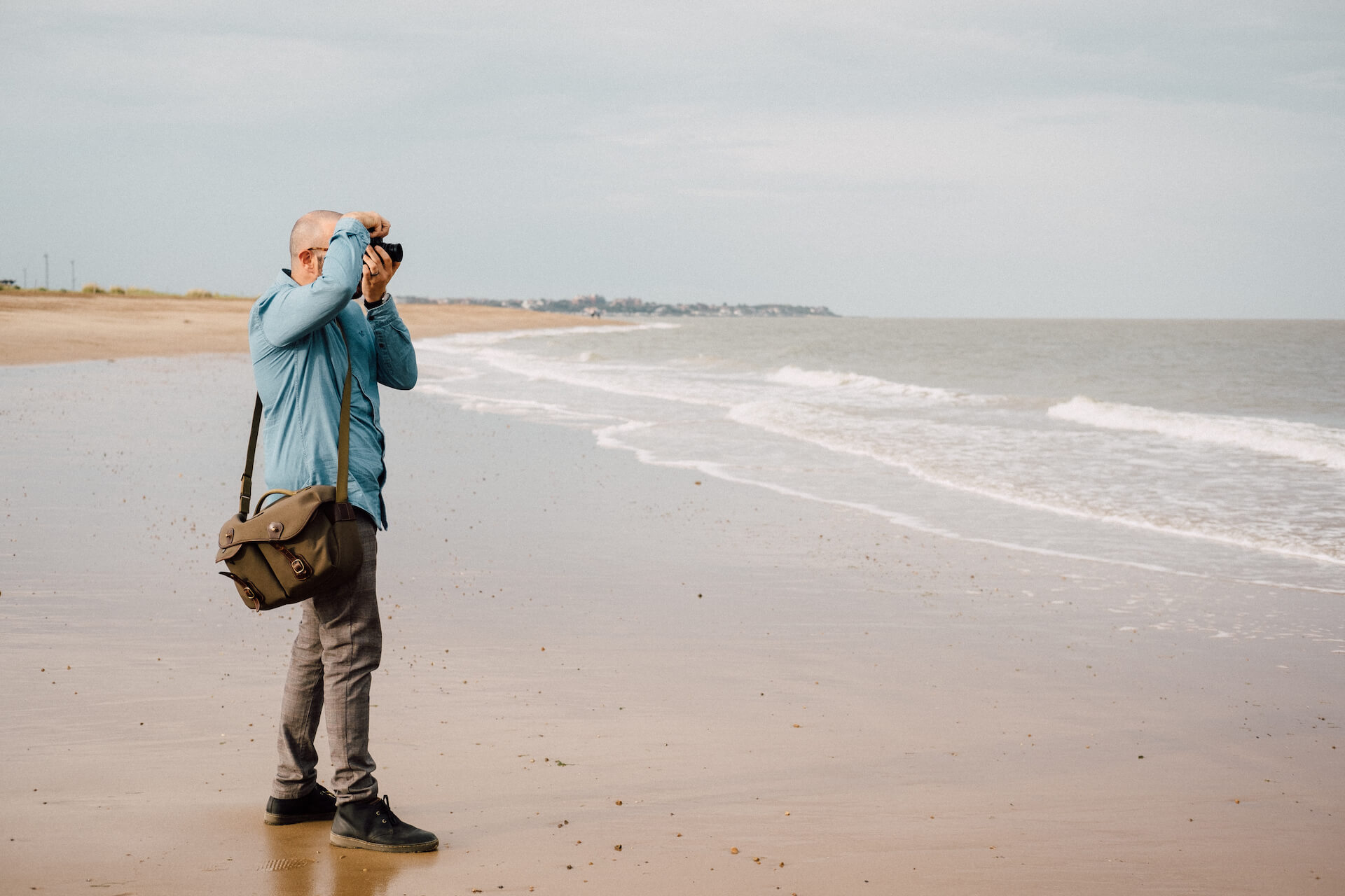 Landscape image of Daniel Ian taking a photograph