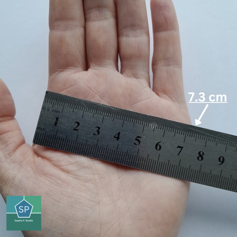 Ruler on hand to measure palm width