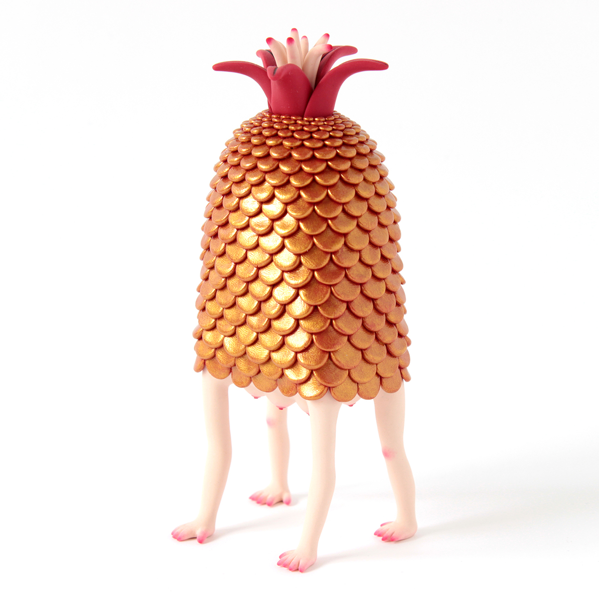 Polymer clay sculpture of a strange creature with human legs, tits, scales, and a flower on topegs