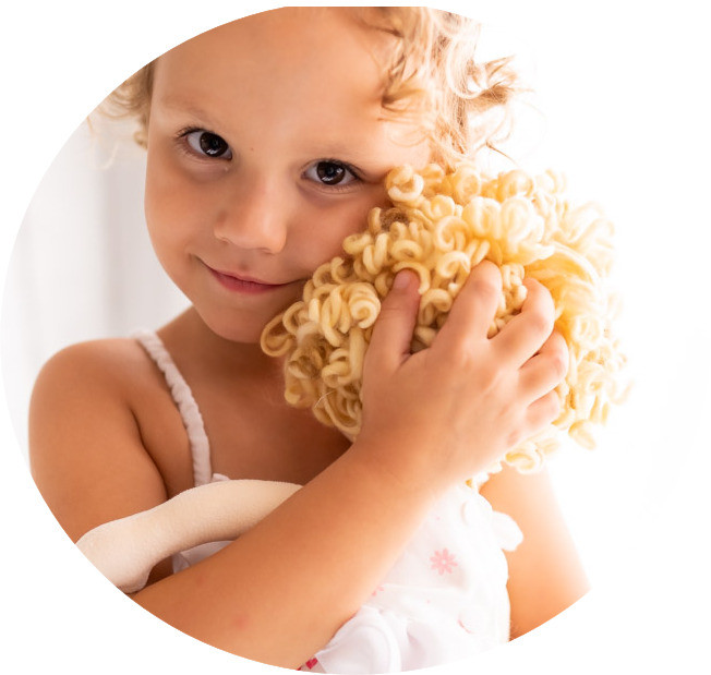 girl with curly hair holding doll with curly hair