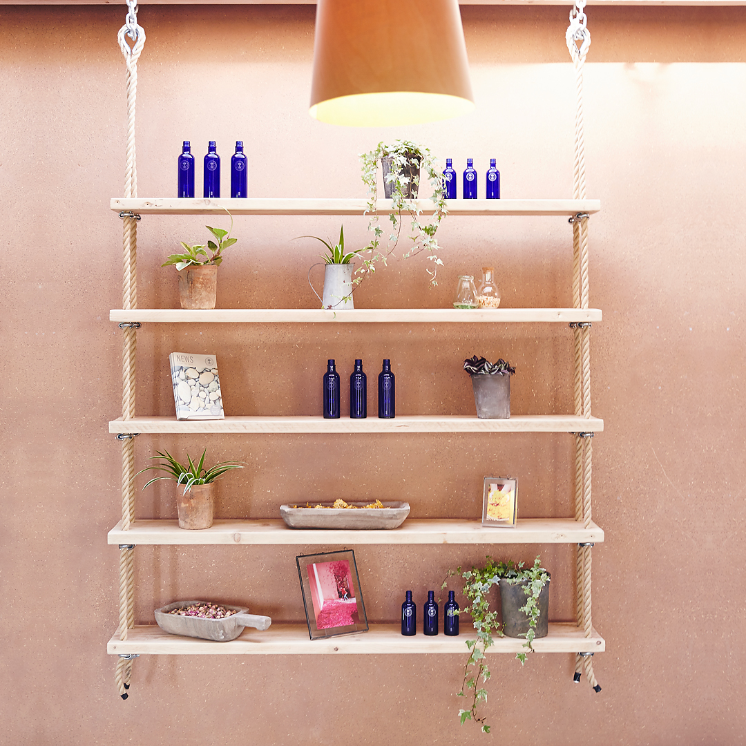 Rope shelves hanging in Neals Yard Remedies canteen in Dorset