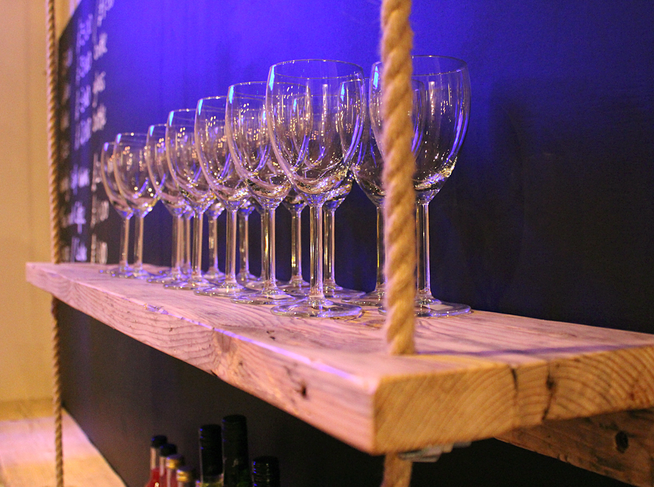 Scaffold board shelf holding wine glasses