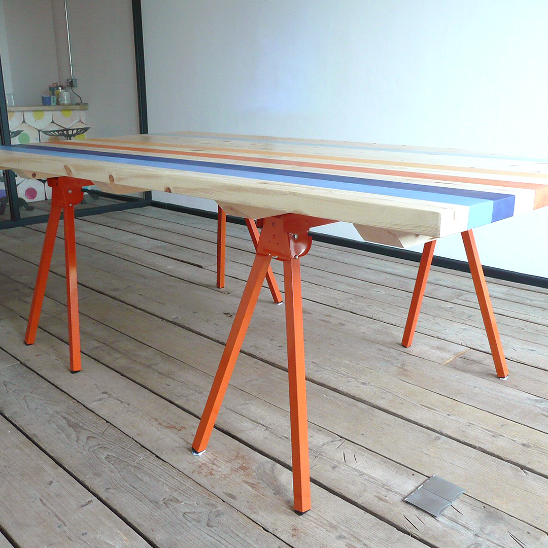 Striped table with bright orange legs in conference room