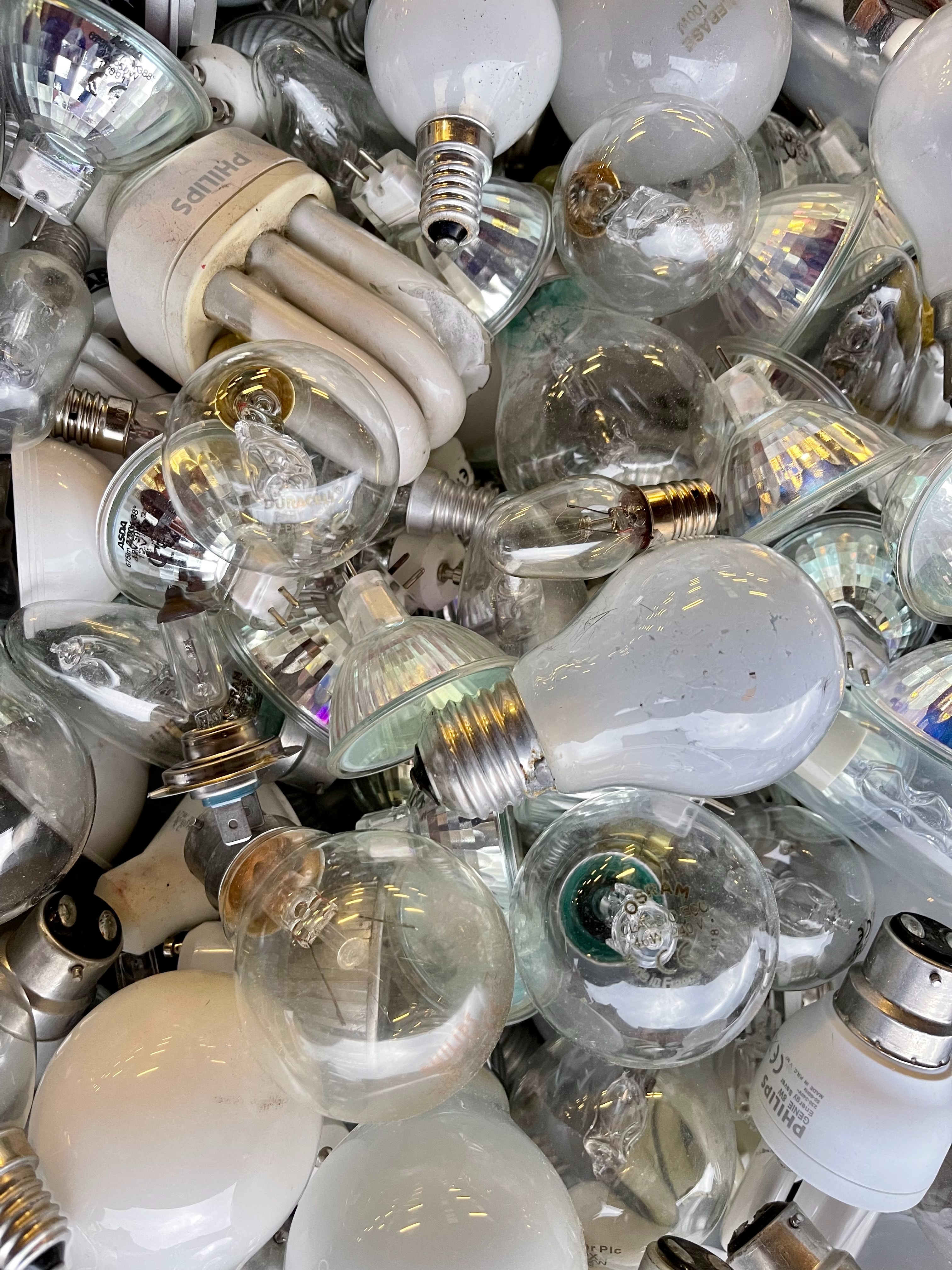 a pile of used and and broken lightbulbs