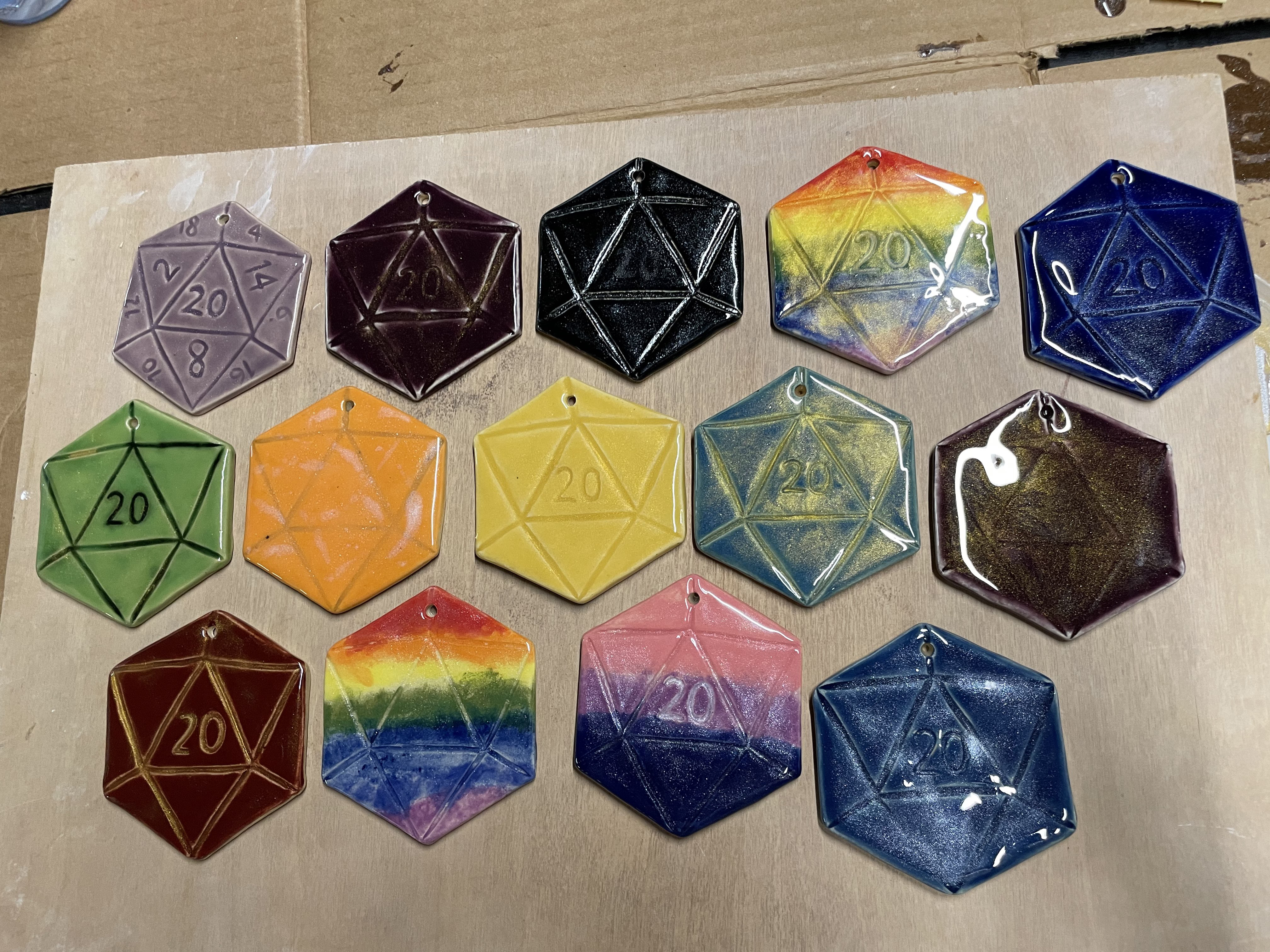 d20s laid out next to each other in different glazes