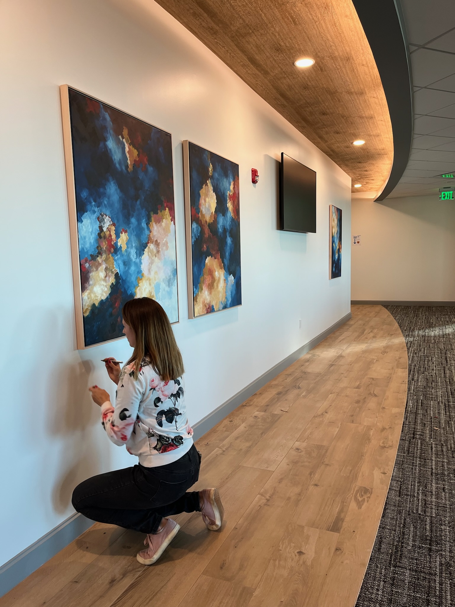 Hanging artwork in a professional office space