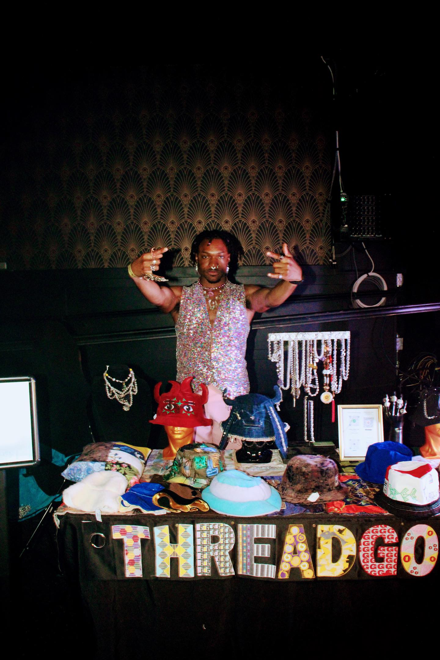 Abdul-Malik Ford standing behind the ThreadGoldz booth at the Sho-Nuff Parties Retro Rewind event