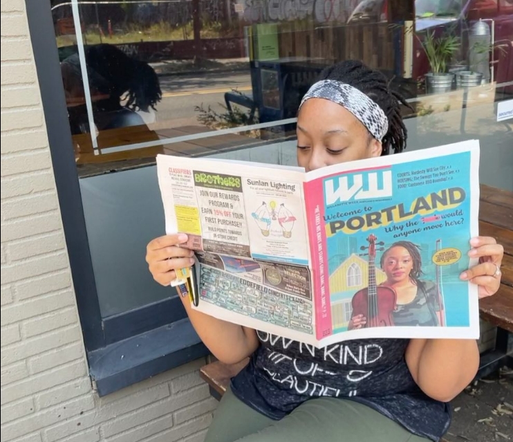 Model reading newspaper with her face on the cover