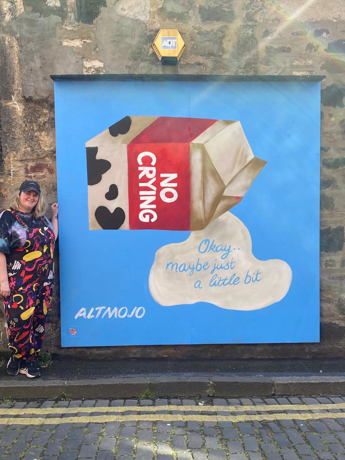 Altmojo posing next to street art painted at Quality Yard in Leith
