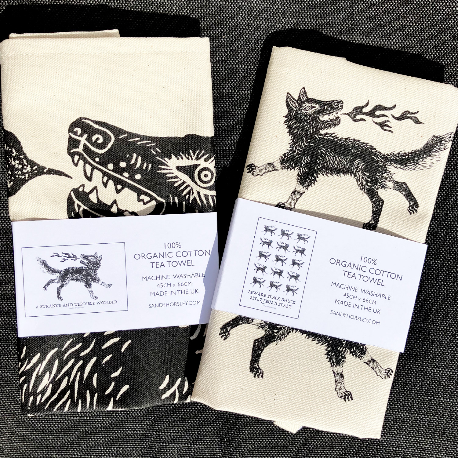 Pair of Black Shuck tea towels by Sandy Horsley