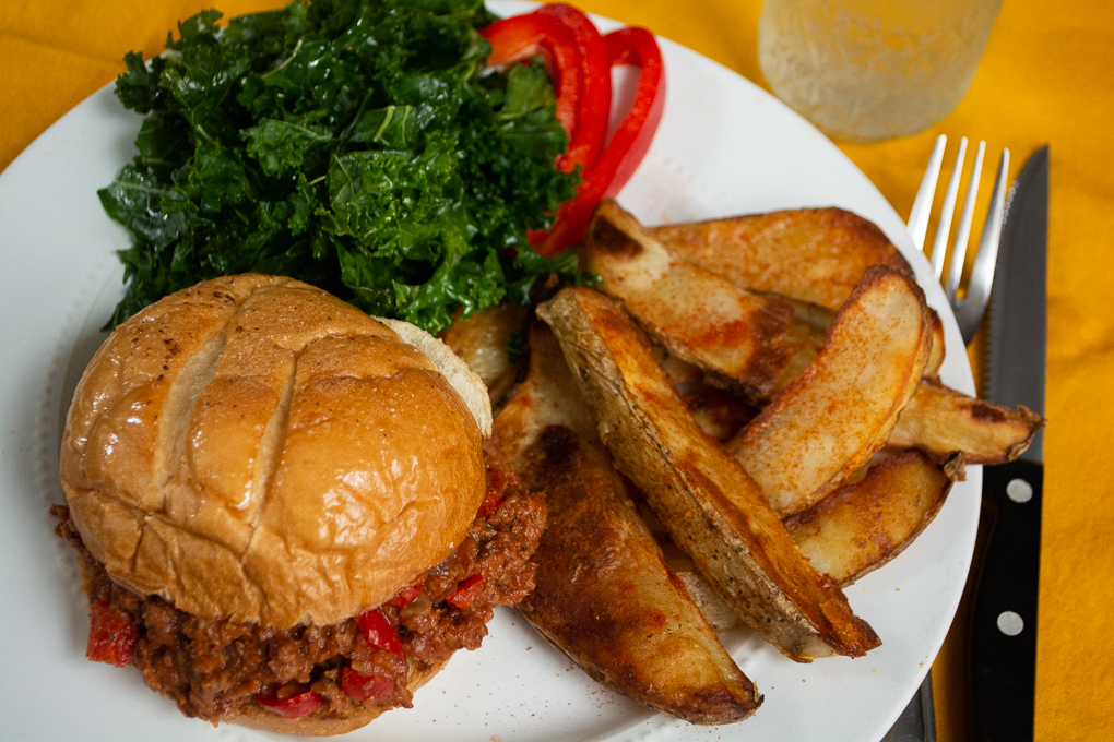 sloppy joe plate with steak fries and kale salad