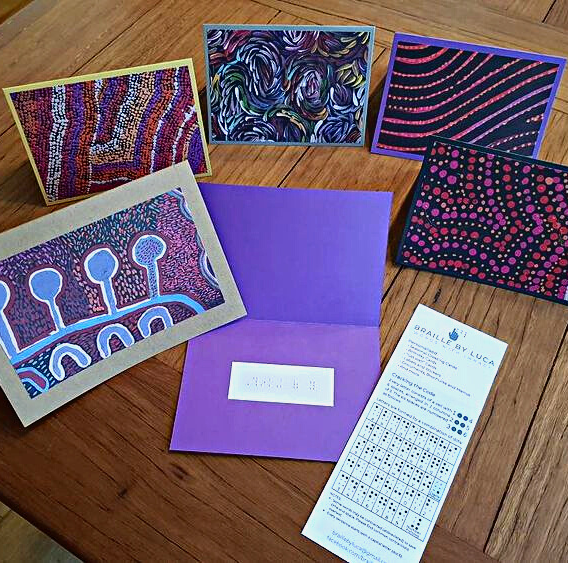 A photo of a variety of colourful cards with Indigenous art on their covers. 