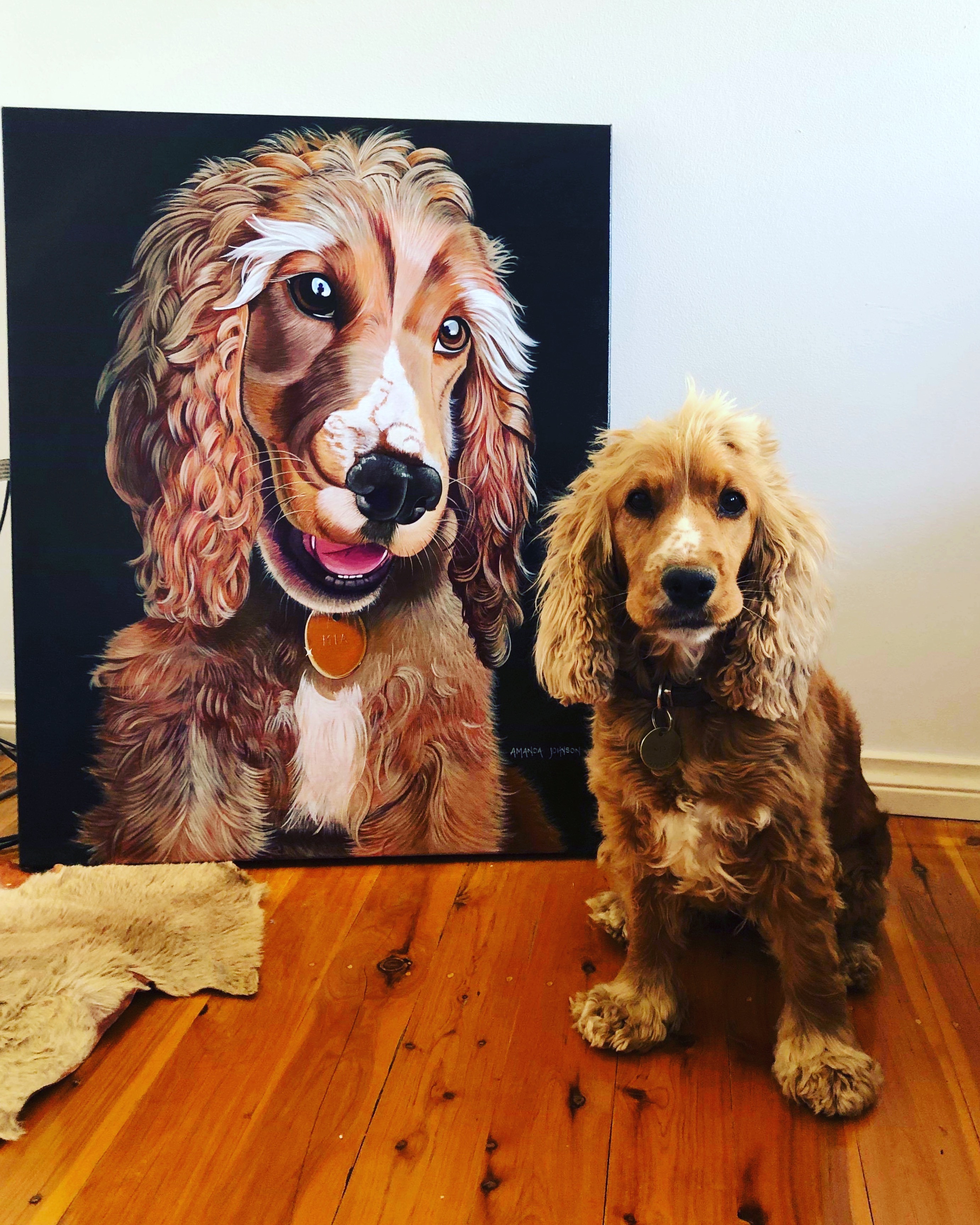 Mia the dog poses in front of her commissioned portrait (she doesn't look too impressed, but her mum was & that's the important bit)