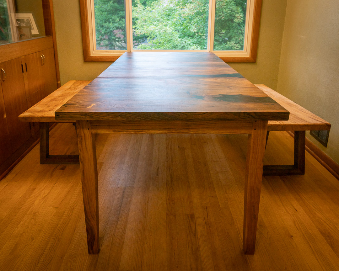 Bastogne walnut dining table with sweet cherry legs