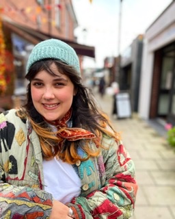 Anaïs wearing the Cosmic Fisherman Hat in green.