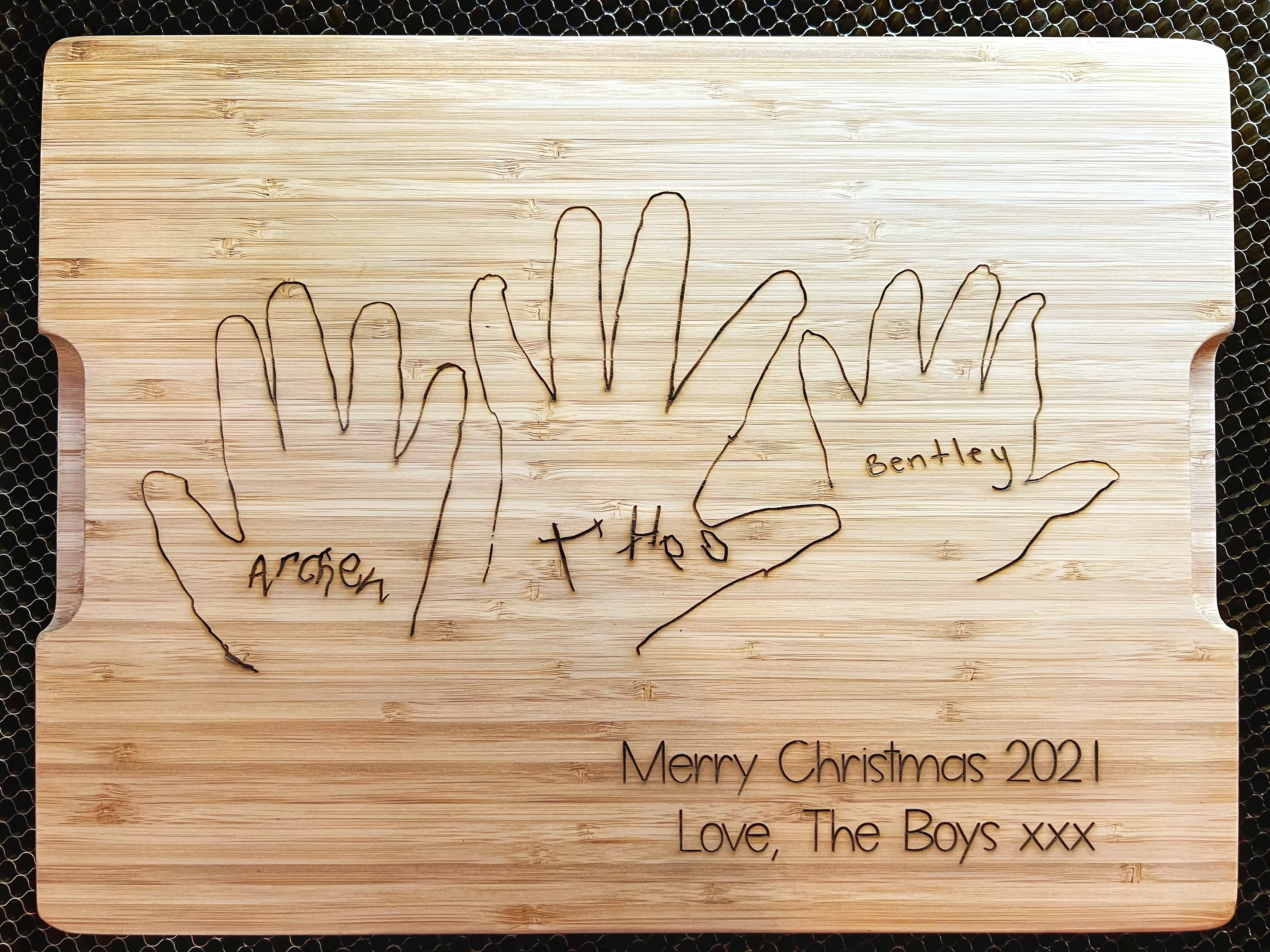 handprints etched onto a chopping board
