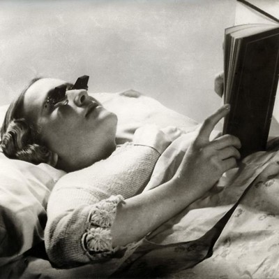 Woman with sunglasses reading