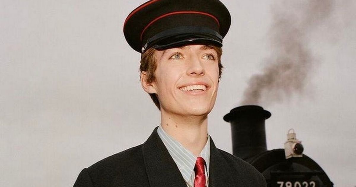 Francis Bourgeois dressed in a train conductors uniform smiling