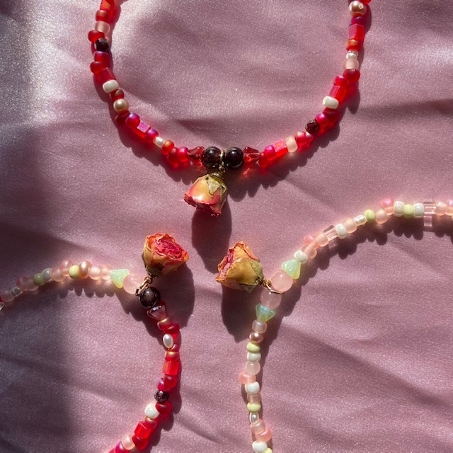 three necklaces with rose charms