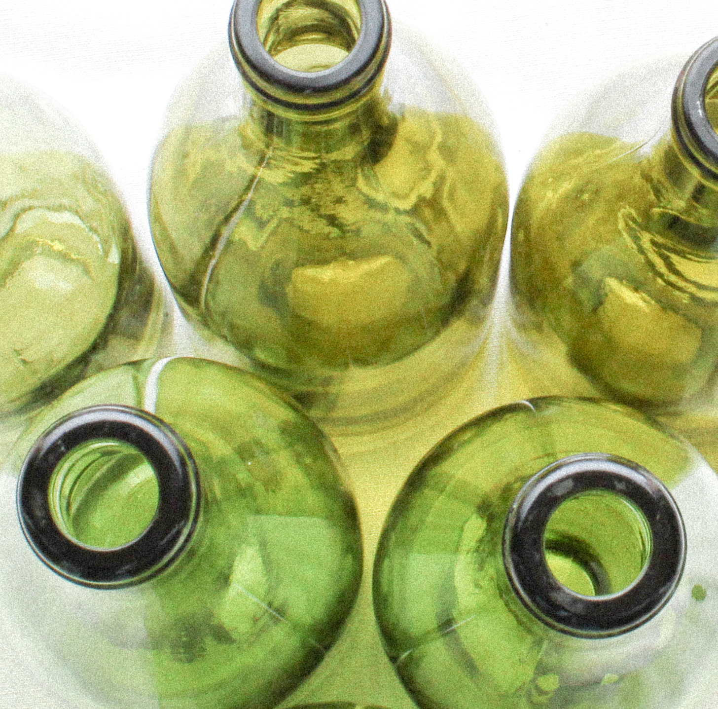 A collection of vintage French wine bottles to be used for recycled jewelry.
