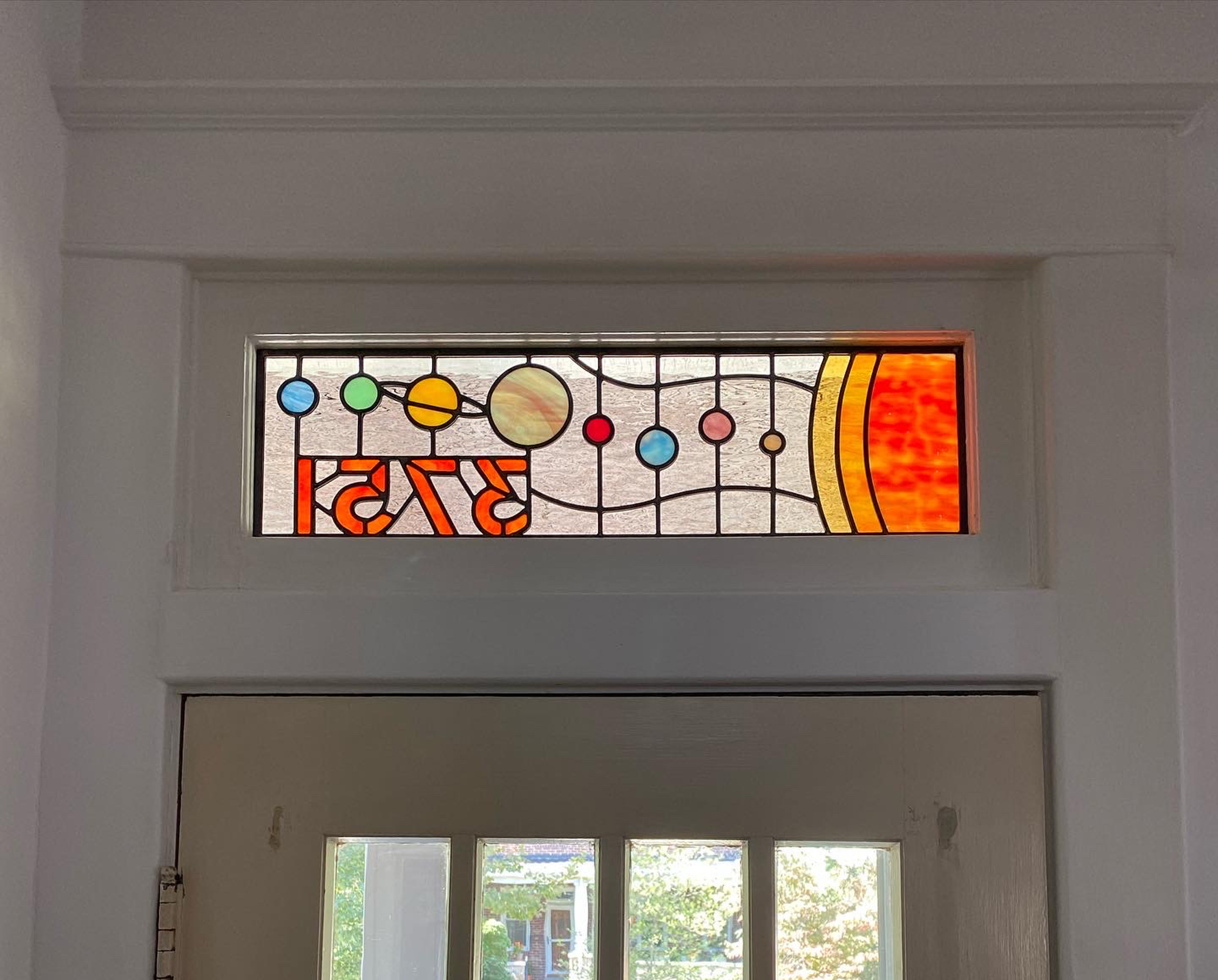 Stained glass transom with solar system
