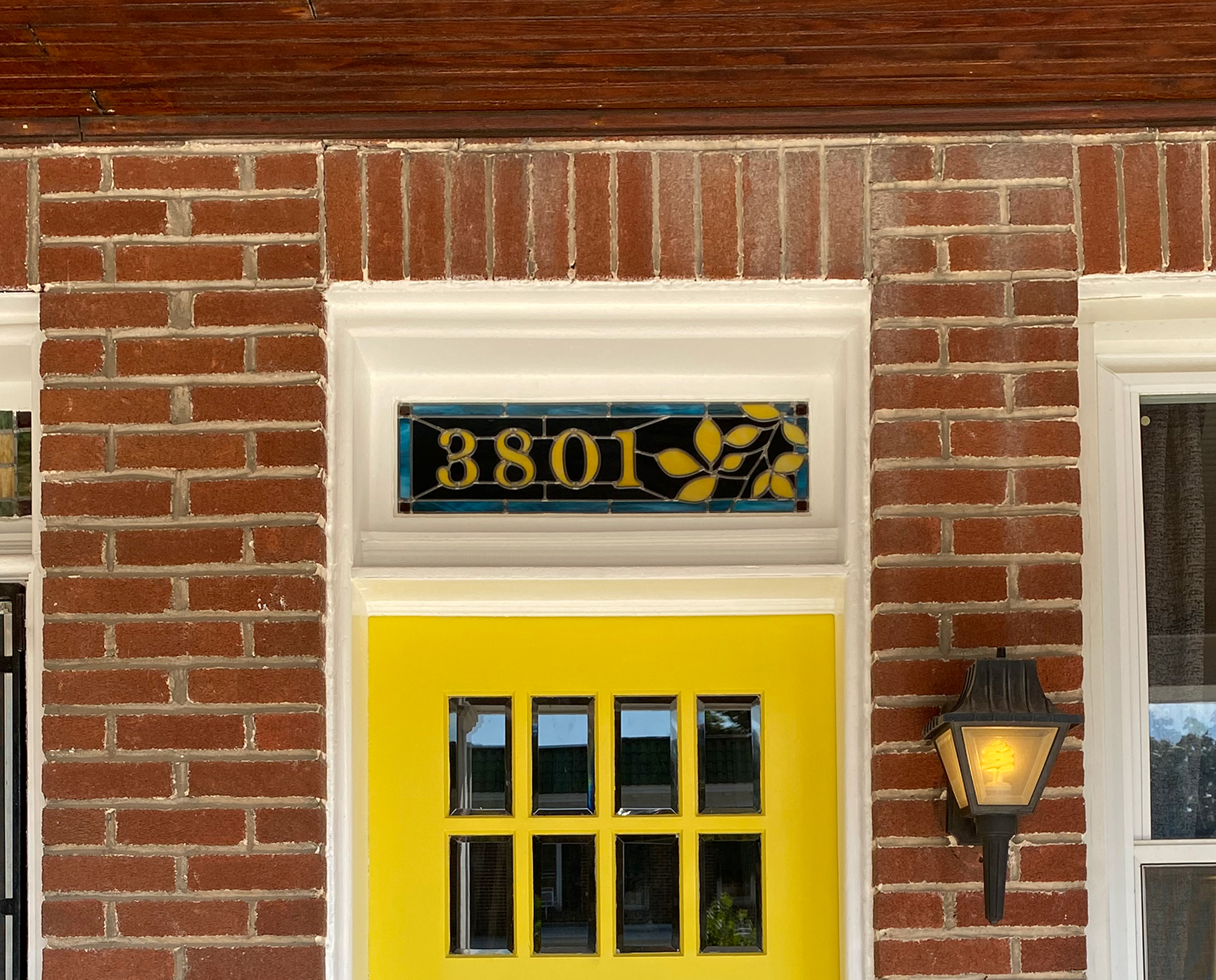 Stained glass transom with beech tree branch