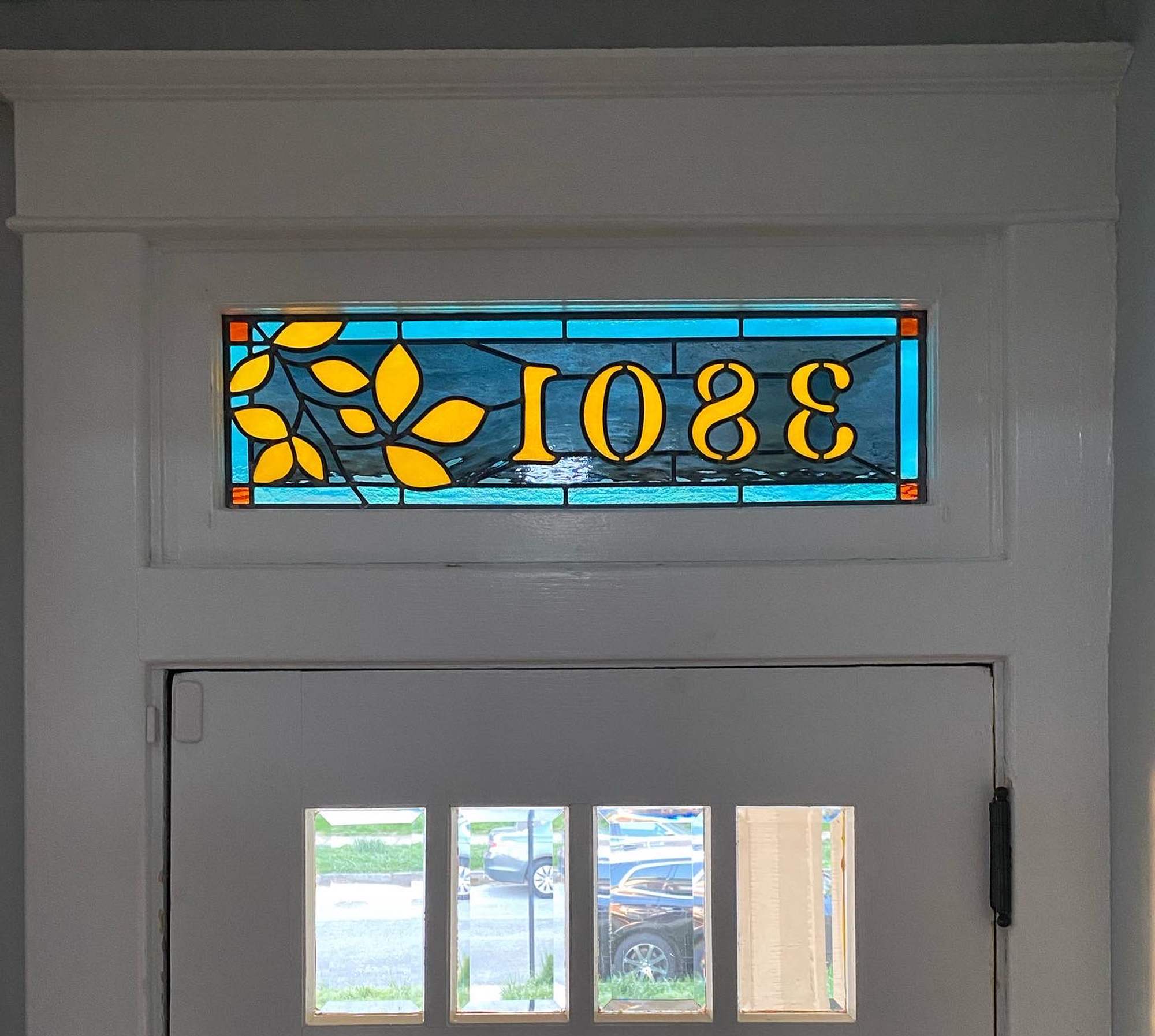 Stained glass transom with beech tree branch