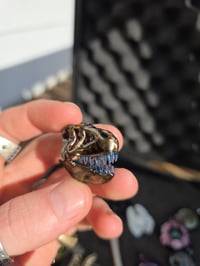 Image 1 of Mini electrum T-Rex skull pendant.