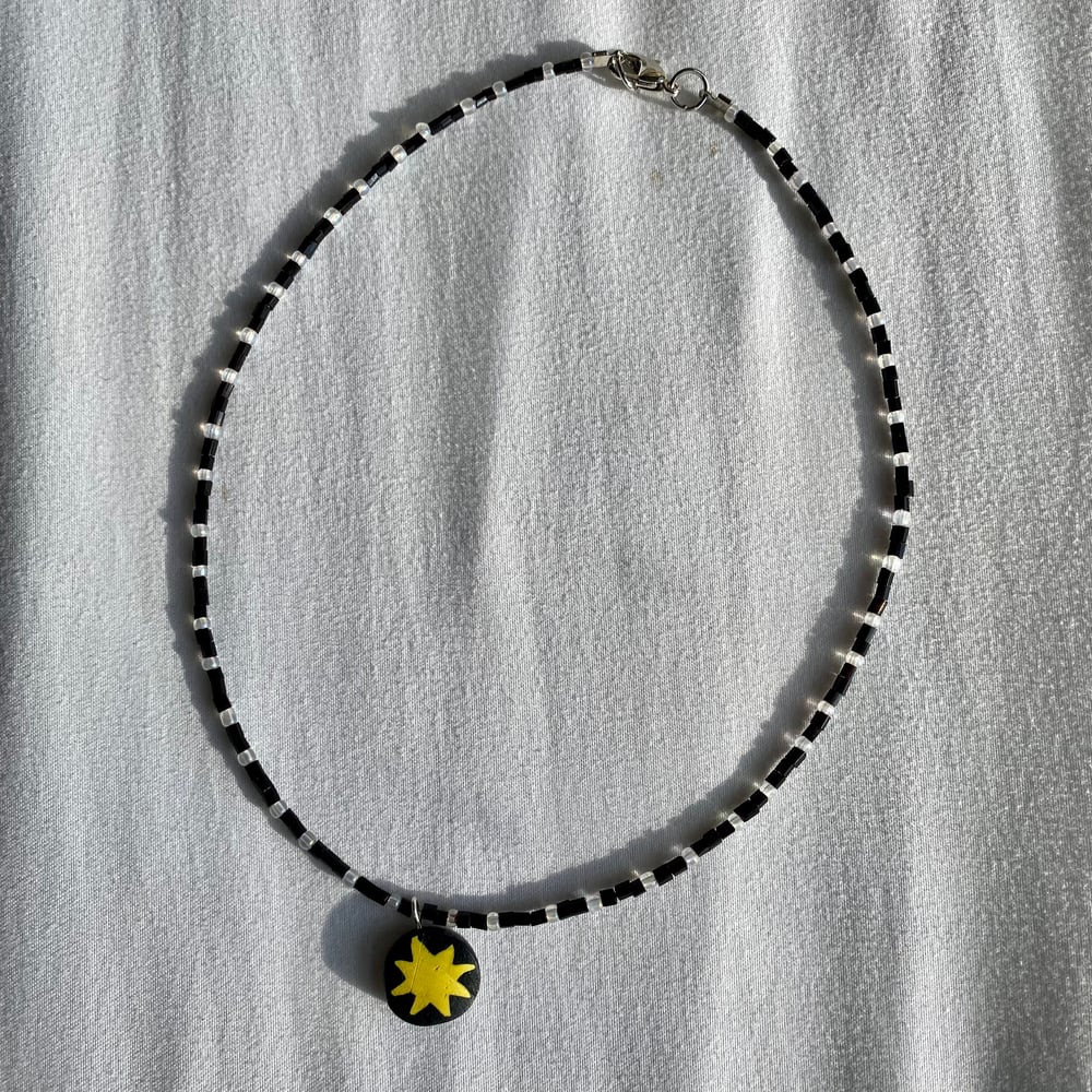 Image of black and white star charm necklace