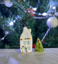 Image 1 of Big House with lights and a Christmas Tree