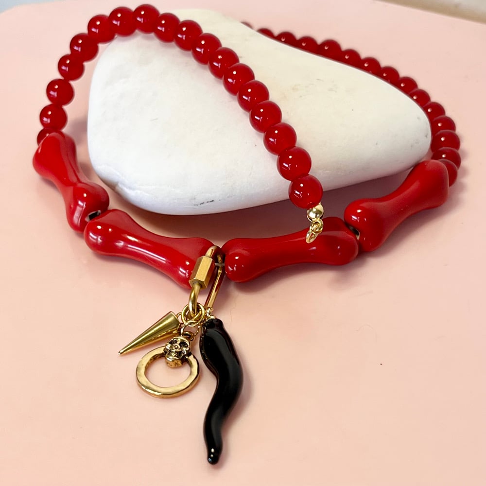 Image of Red glass bead and bone necklace with wiggly tusk