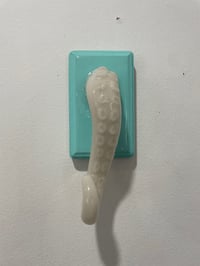Image 1 of Single glow in the dark tentacle on teal jewelry holder