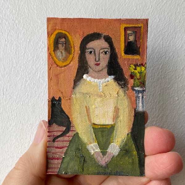 Image of girl with green skirt and cat companion 