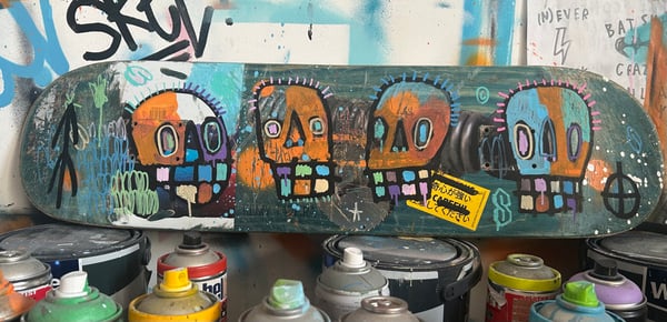 Image of 4 skull skate deck