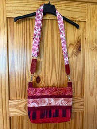 Image 1 of Red Cross body with adjustable stry