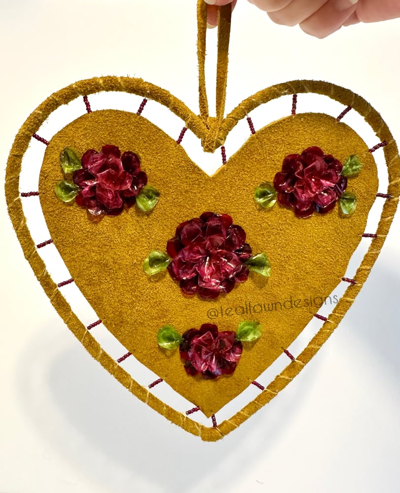 Image of Heart shaped fish scale art on deer hide- burgundy, red floral