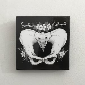 Pelvis Bones And Flowers Print On Wooden Panel