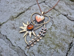 Heart pendant with orange flower