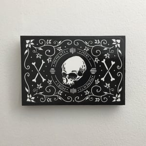 Skull And Scrolls Linocut Print On Wooden Panel