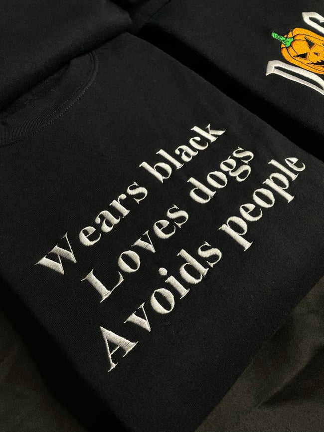 WEARS BLACK LOVES DOGS AVOIDS PEOPLE