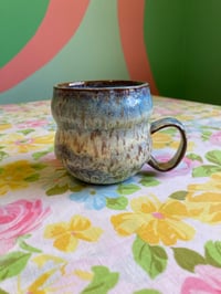 Image 1 of blue and yellow speckled teacup