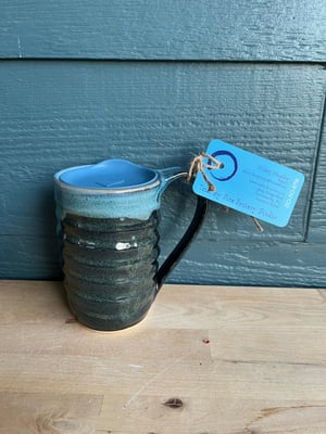 Image of M55 Large mug, black bum with blue inside—overlap is blue