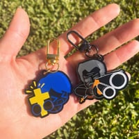 Image 1 of John Ward and Father Garcia acrylic charms from Faith: The Unholy Trinity