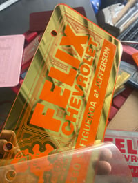 Image 1 of GOLD & ORANGE FELIX CHEVROLET ICONIC LICENSE PLATE