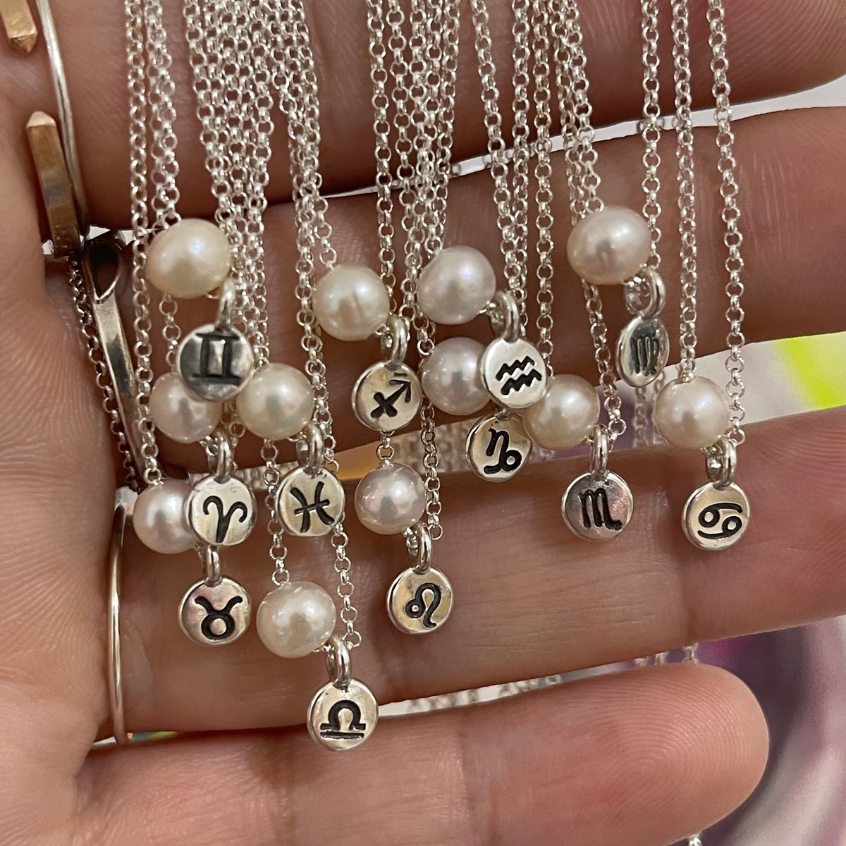 Image of zodiac sign and pearl necklace