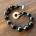 Image of Hand Knotted Tahitian pearl bracelet with puka shell clasp