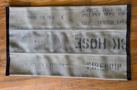 One-of-a-kind: MADE IN THE USA marking Fire Hose Rug