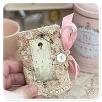 Image 7 of A Petite French tin with a needle book and tattered pin cushion