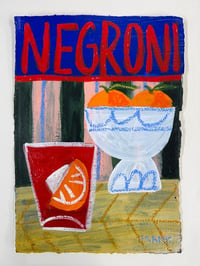 Negroni with orange bowl on blue