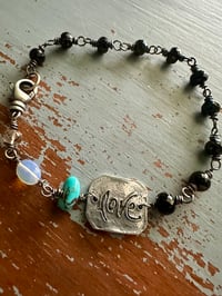 Image 1 of faceted gemstone and sterling silver medallion bracelet